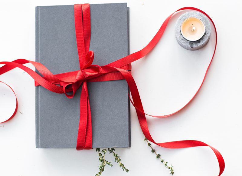 book gift with red ribbon